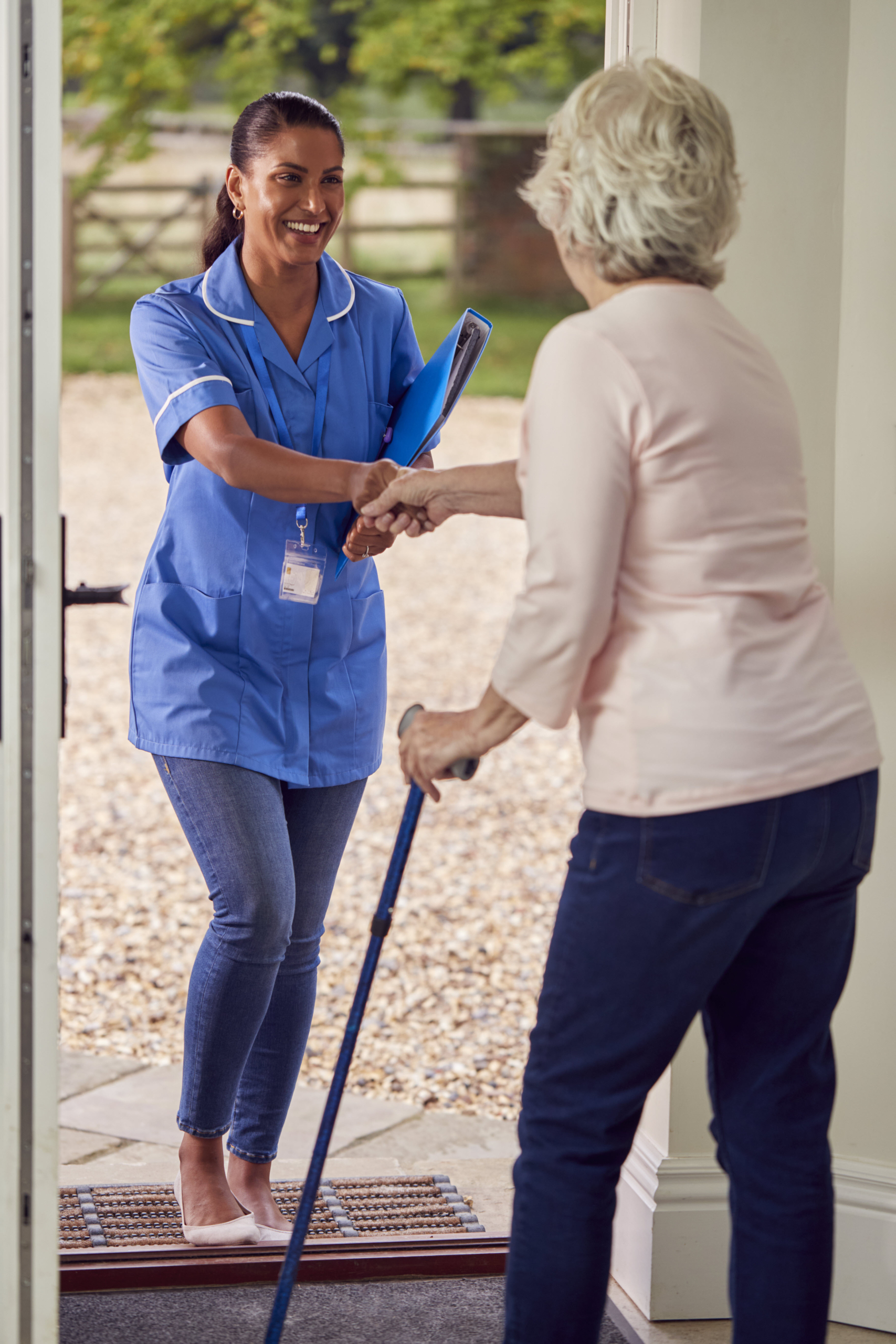 At-Home Care Worker Greeting Senior at Front Door