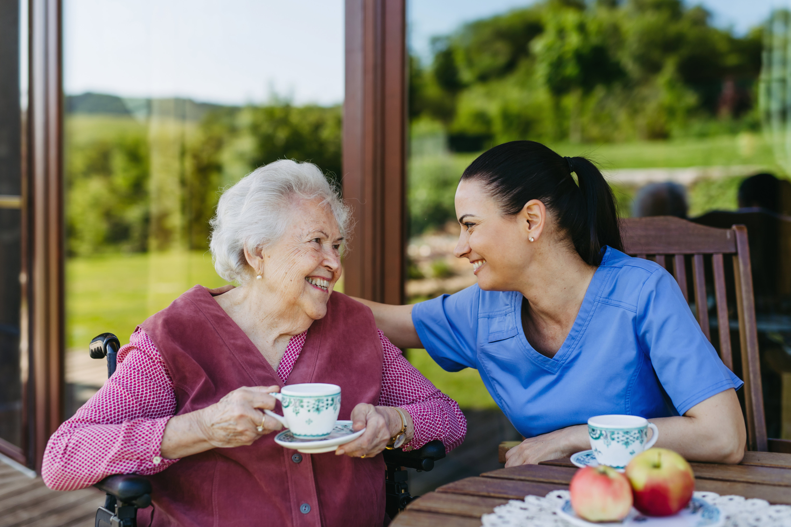 Caregiver Drinking Tea with Dementia Patient