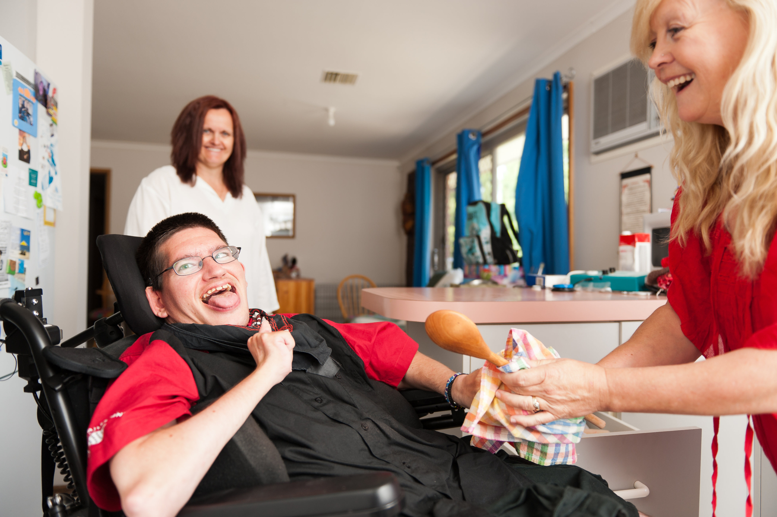 Man with Disability with Caregiver at Meal Time