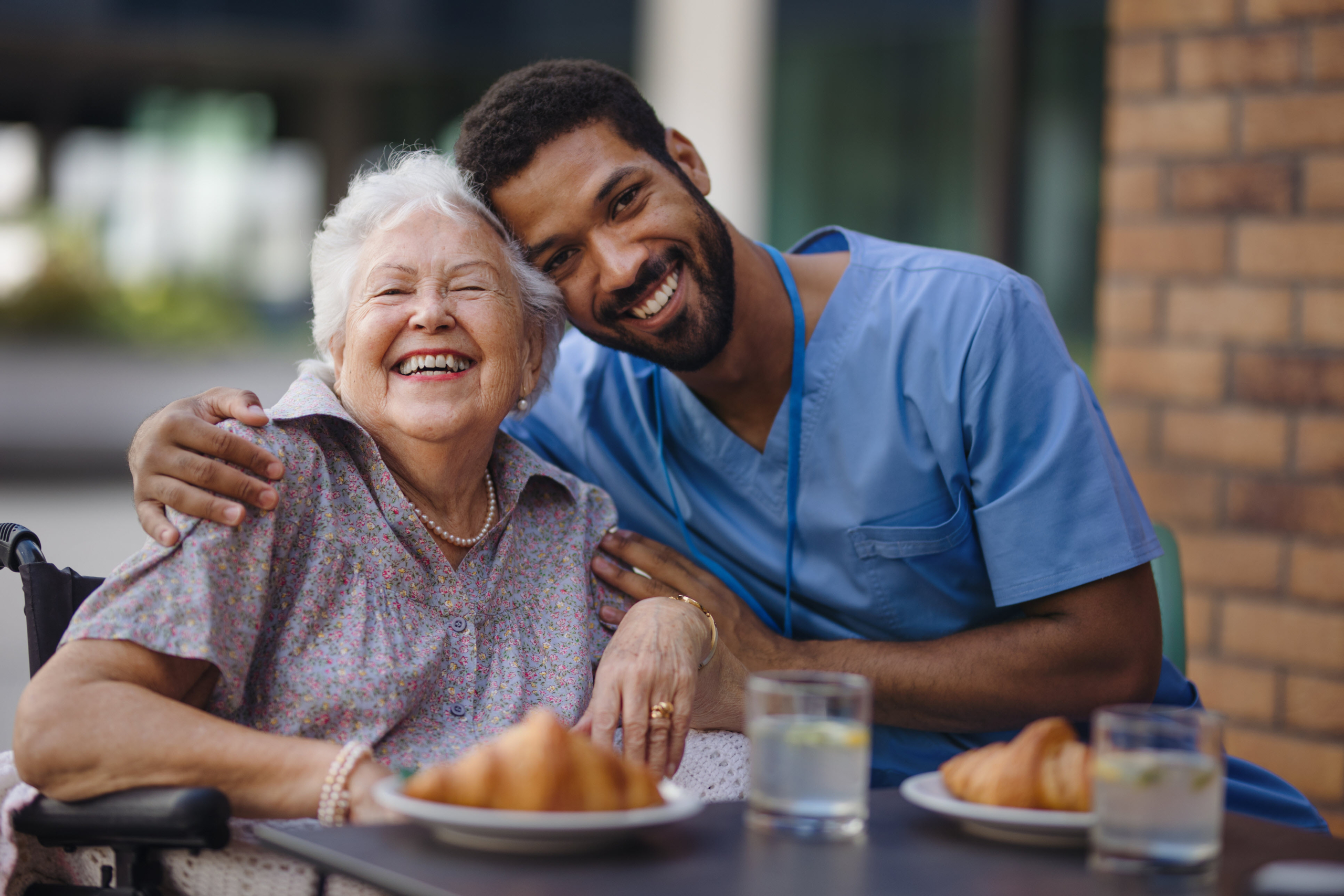 Caregiver eating breakfast with client