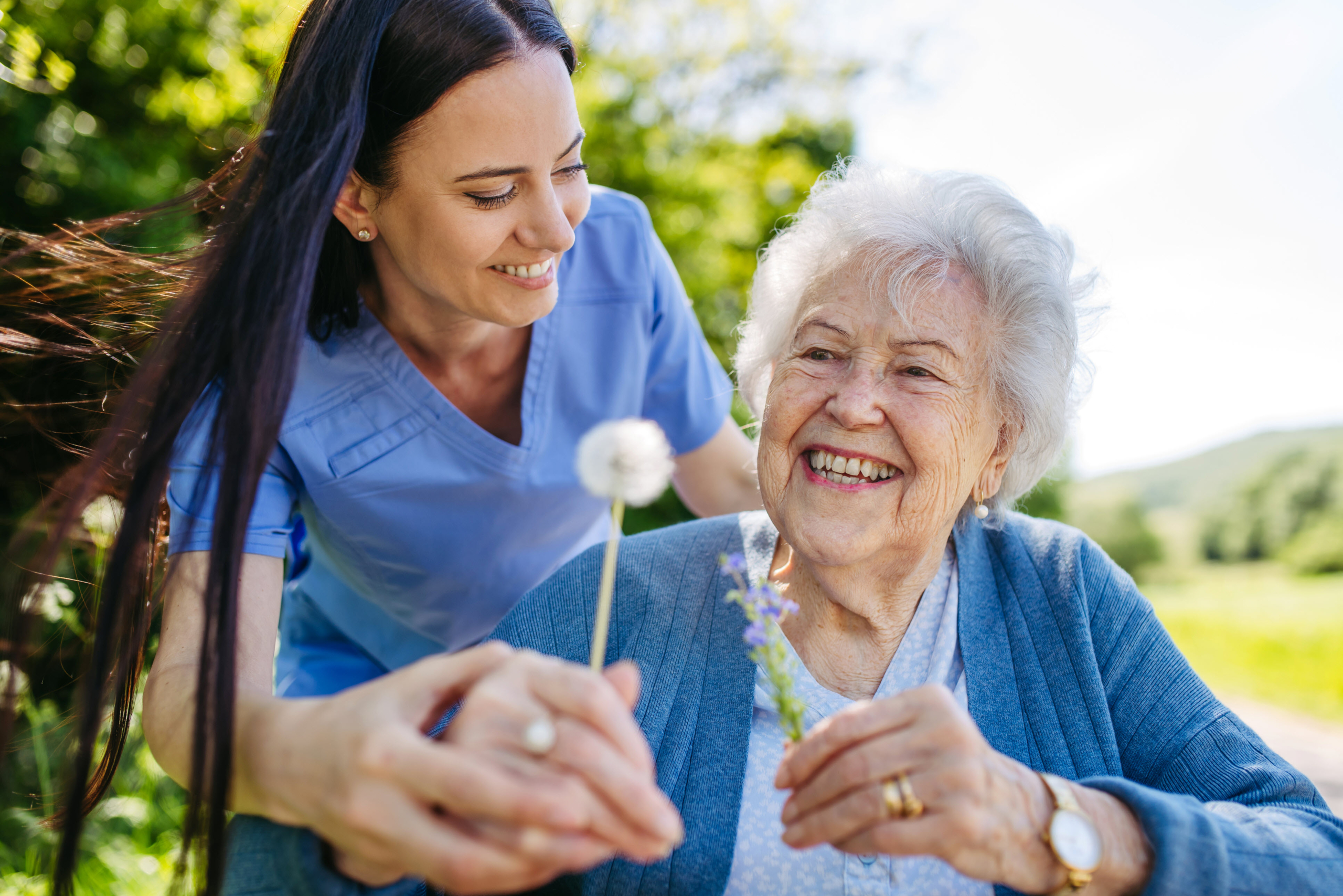 Caregiver with patient outside enjoying nature