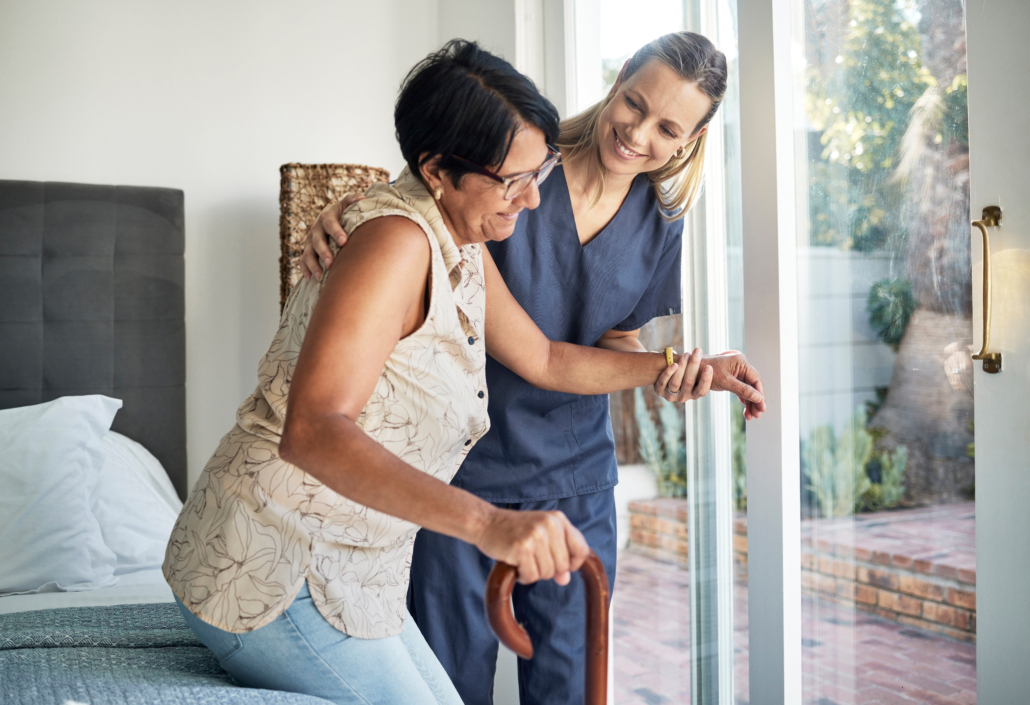 At-Home Caregiver Helping Patient Out of Bed