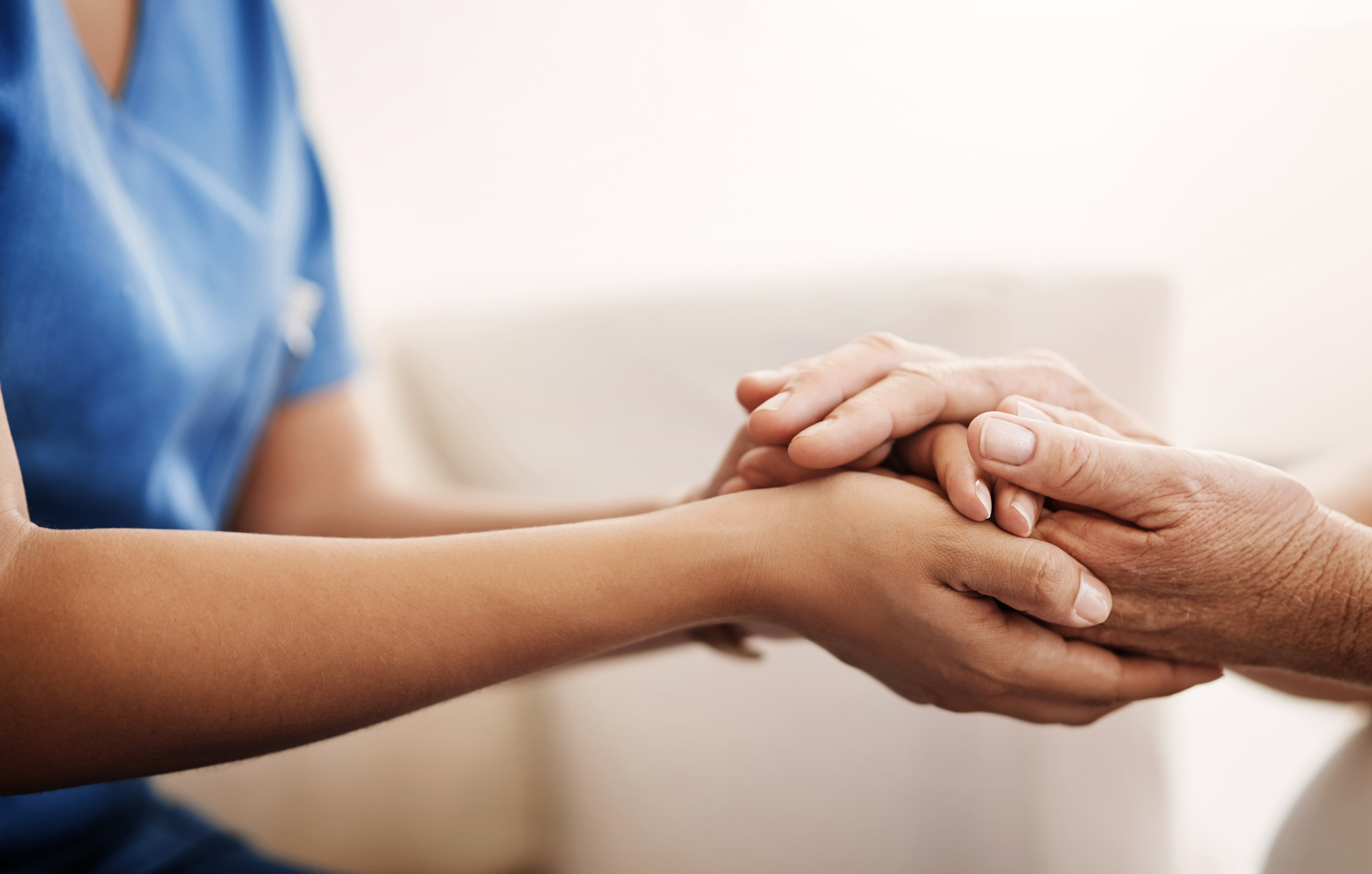 Caregiver Holding Elderly Person's Hand
