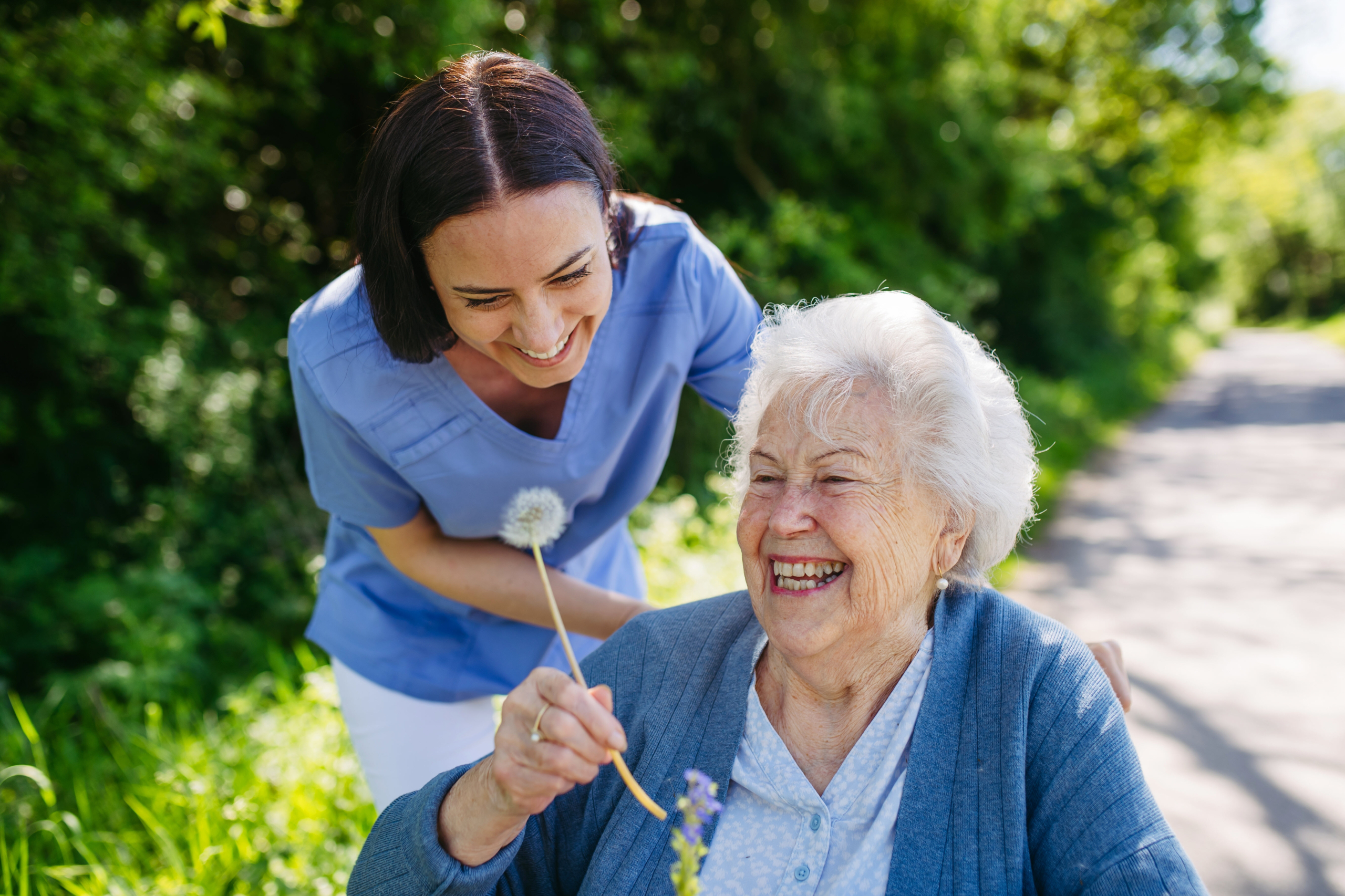 Home Care Resources & Family Guides Caregiver and senior out for a walk